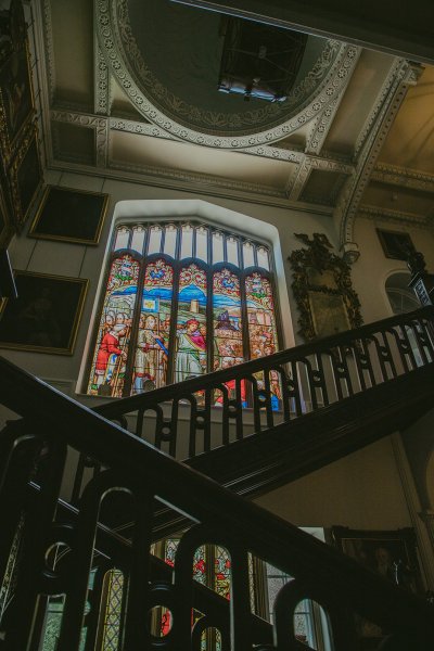 Interior church tinted windows and wooden staircase detail