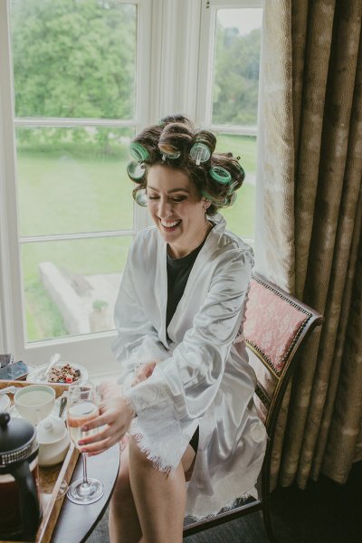 Bride hair detail drinking champagne curlers