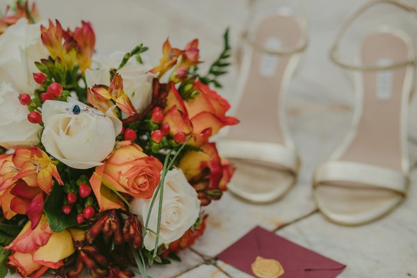 orange red flowers bridal heels and Black Opium Yves Saint Laurent perfume