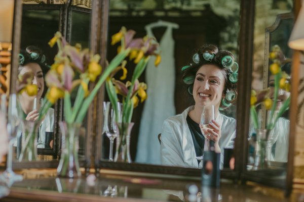 Yellow sunflowers and bride wearing curlers in hair champagne