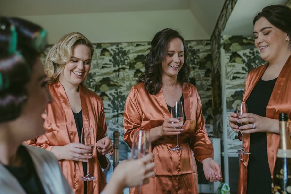 Orange satin bridalwear bridesmaids cheers champagne