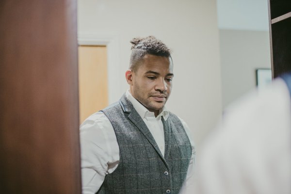 Groom with suit on getting ready