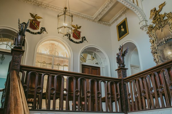 Interior wooden brown staircase and portraits