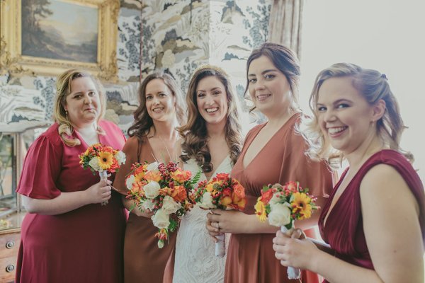 Bride and bridesmaids smile flowers bouquet