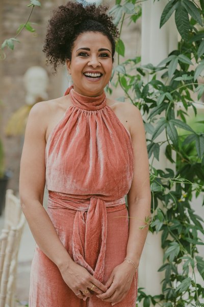 Mother in suede salmon coloured jumpsuit smiles