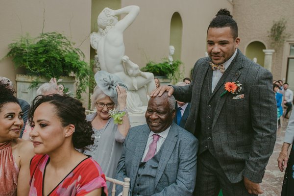 Groom father and mother sit in audience guests