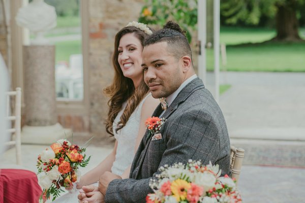 Bride and groom flowers orange roses bouquet sitting