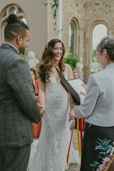 Bride and groom officiant at alter