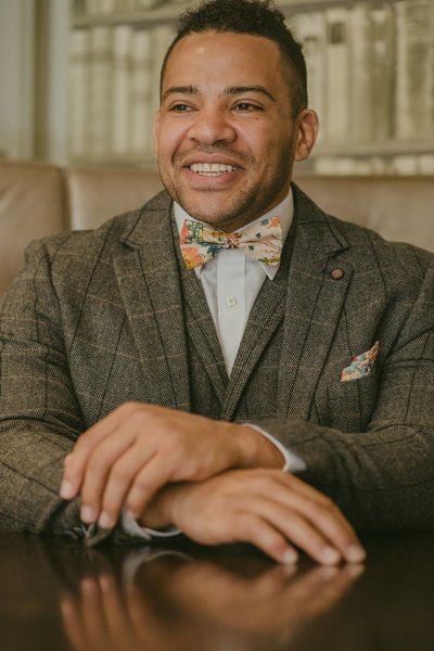 Groom in suit smiling at camera