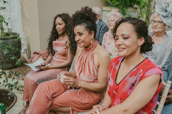 Mother and bridesmaids are emotional in audience