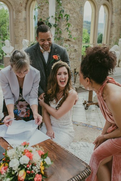 Marriage certificate signing signatures bride laughs