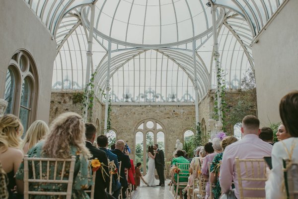 Bride and groom kiss at the alter