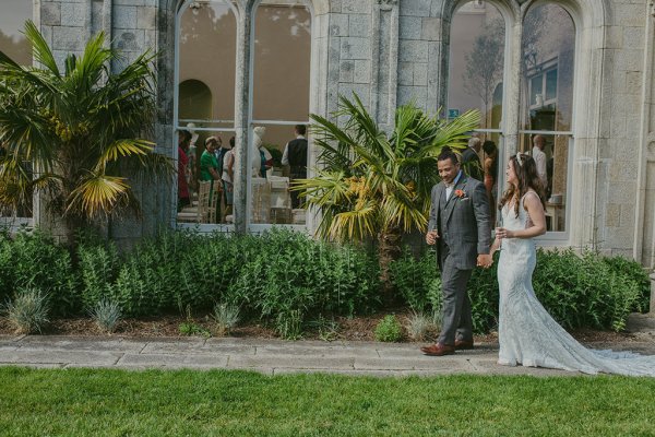 Bride and groom exit onto grass