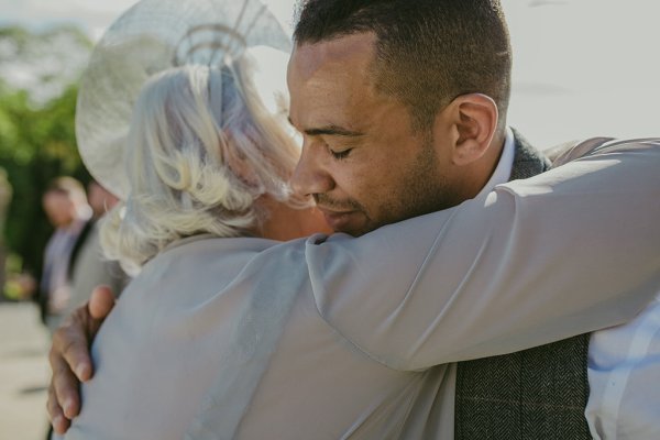 Groom hugs brides mother embrace