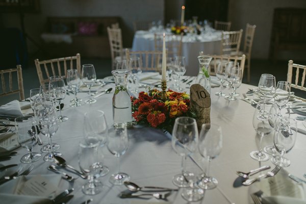 Table cutlery setting and glasses flowers and candles