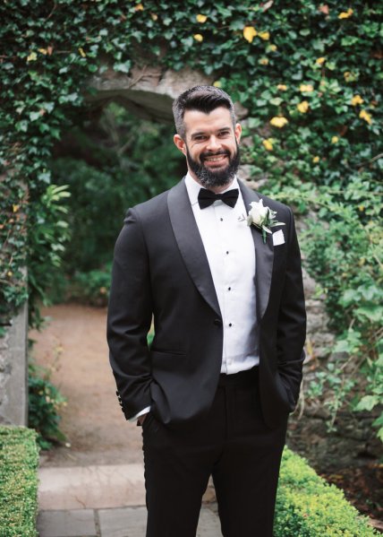 Groom poses in the garden