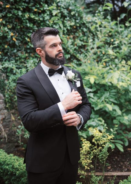 Groom in garden wearing tuxedo