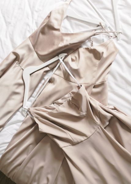 Bridesmaids gowns laid out on bed