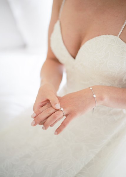 Close up detail of brides jewelry ring accessory bracelet