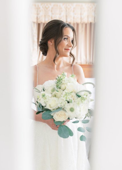 Bride holding bouquet flowers white roses