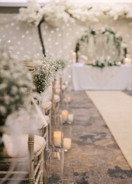 Empty ceremonial room candles are lighting seats and gold carpet