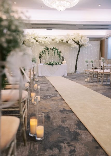 Empty ceremonial room candles are lighting seats and gold carpet