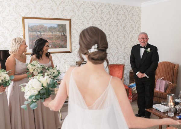 Bride grandpa and bridesmaid in room