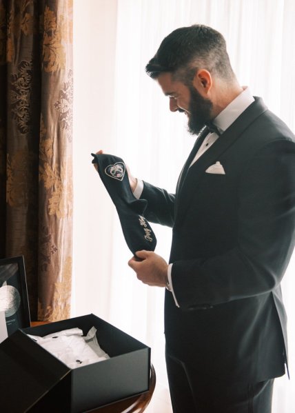 Groom opens funny sock gift present