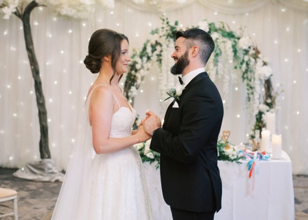 Bride and groom at the alter holding hands