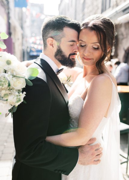 Bride and groom embrace on Irish street town