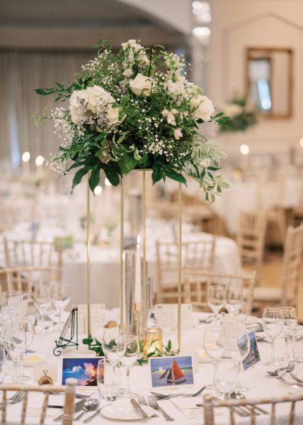 Empty dining room table room flowers chairs cutlery and lights