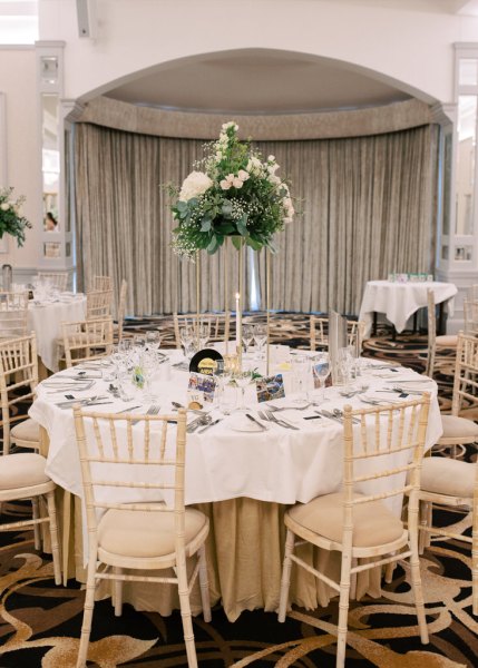 Empty dining room table room flowers chairs cutlery and lights