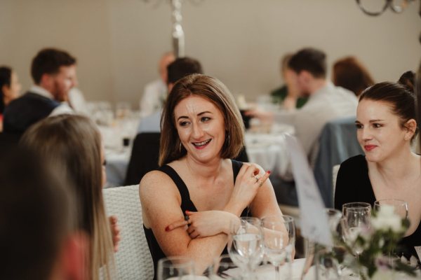 Woman seated smiling/chatting