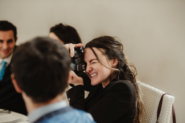 Guest seated with camera photographer photography