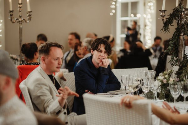 Men sitting and talking at table