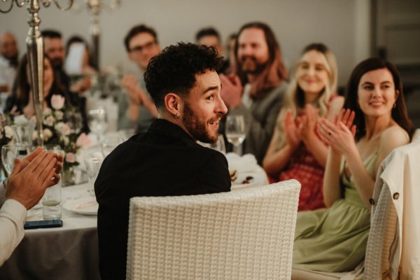 Man in audience looking at speeches