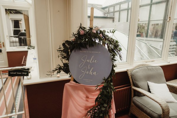 Julie & John circular plaque covered in ivy