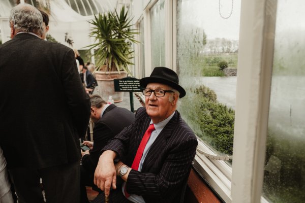 Man wearing black hat and suit