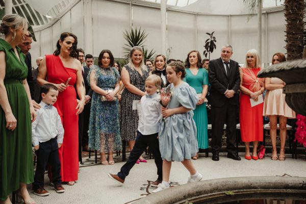 Two children little boy and girl walk down the aisle