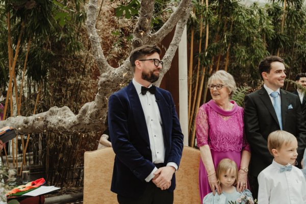 Groom awaits bride during ceremony