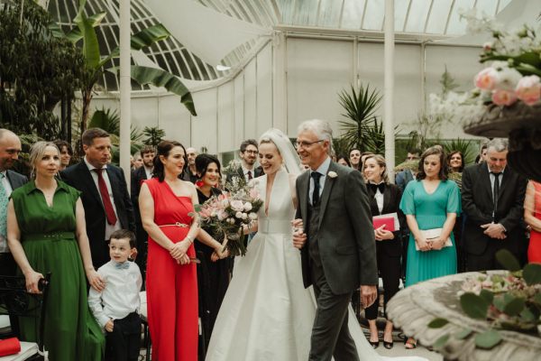 Father walks bride up the aisle towards groom