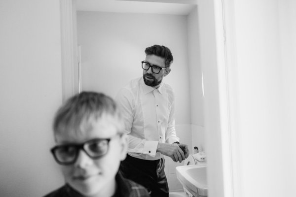 Black and white boy and groom wearing glasses