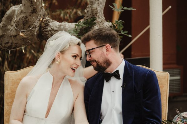 Bride and groom smiling looking at each other