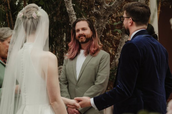 Witness groomsman with groom bride and officiant