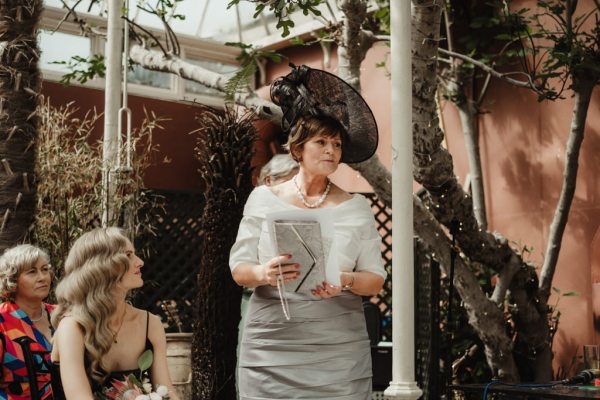 Woman in white dress black hat