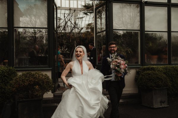 Bride and groom holding flowers/bouquet