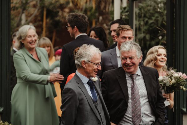 Men in suits guests smiling celebrating