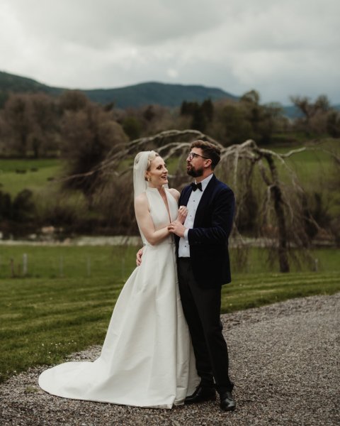 Bride and groom standing in park forest setting