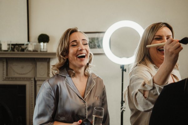 Bridesmaid laughs ring lights in background