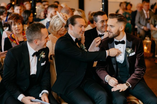 Groom and groomsmen wearing suit and tie bowtie